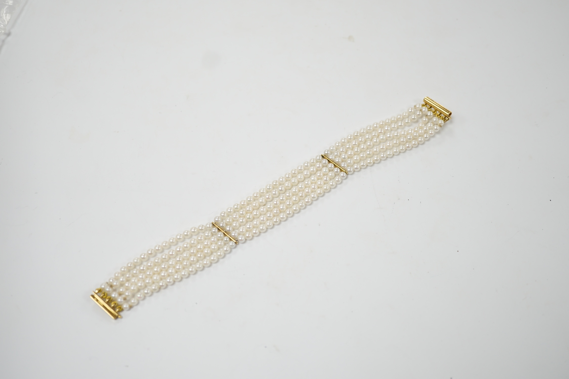 A modern multi-strand cultured pearl bracelet, with 18ct gold clasp, 17cm, gross weight 16.3 grams. Good condition.